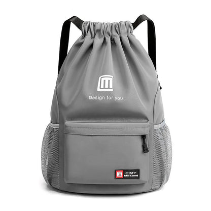 Large bucket-shaped travel backpack in blue with drawstring closure and soft black shoulder straps.