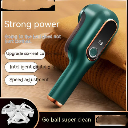Rechargeable green lint trimmer removing fabric balls from wool jumper, digital display showing speed, 15 cm size with spare blades
