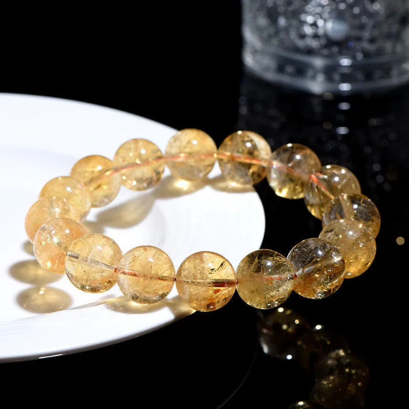 Natural yellow citrine bracelet with geometric beads in various sizes from 4mm to 20.8mm diameter on wrist