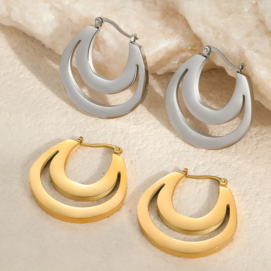 Geometric metallic French earrings in gold or steel colours with round ring design elements