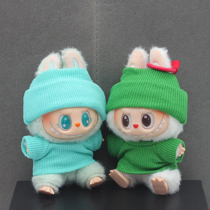 Doll clothes set with knitted flanging hat and T-shirt in multiple colours including pink, white, and stripes.