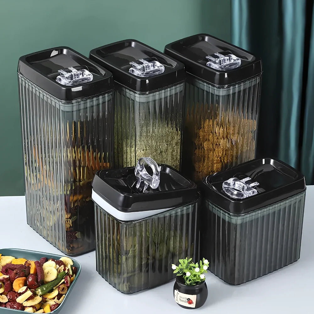 Six black food storage containers with lids in two sizes: two large 3.3-litre and four smaller 1.5-litre jars