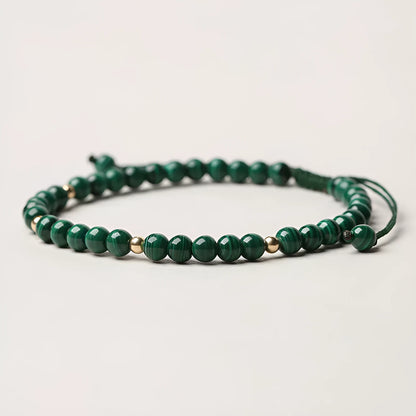 Women's malachite crystal bracelet with golden balls and handwoven design