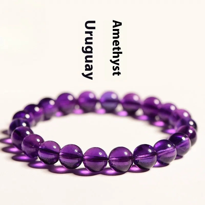 Natural amethyst scattered beads bracelet from Uruguay showing purple crystal beads in various sizes from 4mm to 16mm diameter