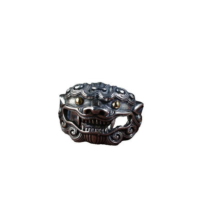 Silver open-style ring with a detailed raised jibeast animal pattern on a model's finger.
