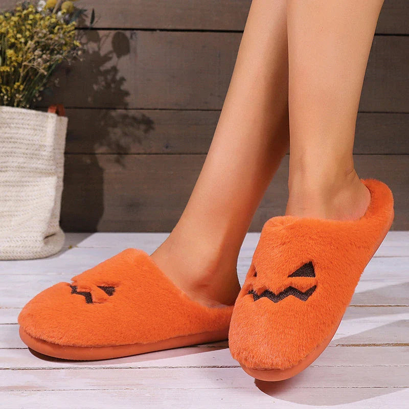 Cozy Halloween pumpkin-themed slippers with plush lining and non-slip soles for comfortable indoor wear