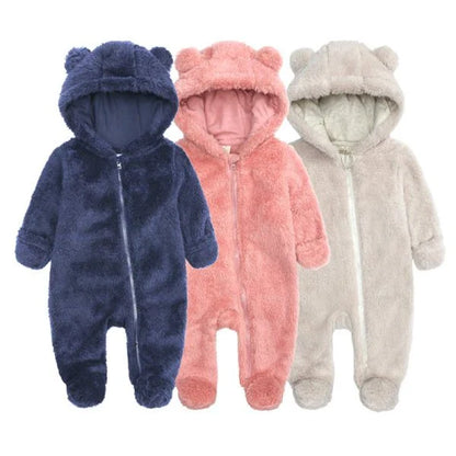 Adorable baby wearing a cozy polyester and cotton hooded jumpsuit with a cute bear-ear design