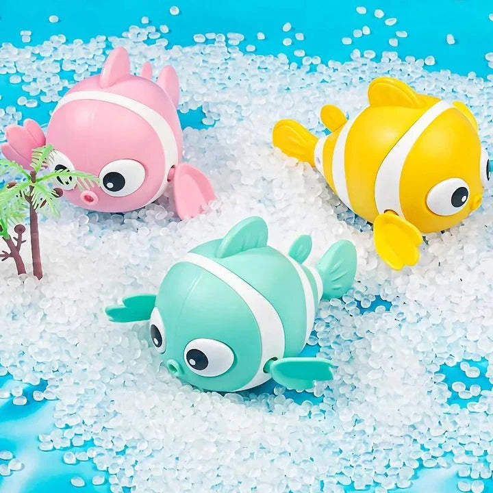 A pink wind-up swimming fish toy for babies and toddlers to play with during bath time.
