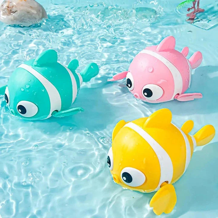 A pink wind-up swimming fish toy for babies and toddlers to play with during bath time.
