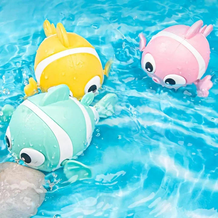 A pink wind-up swimming fish toy for babies and toddlers to play with during bath time.