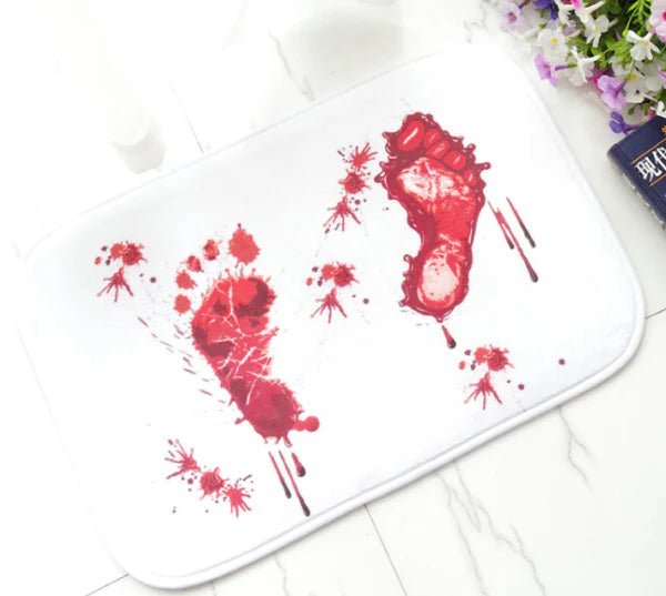 A rectangular bath mat with a vivid, lifelike blood-splatter design made of durable polyester material.