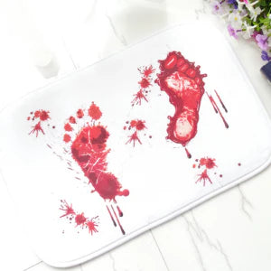 A rectangular bath mat with a vivid, lifelike blood-splatter design made of durable polyester material.