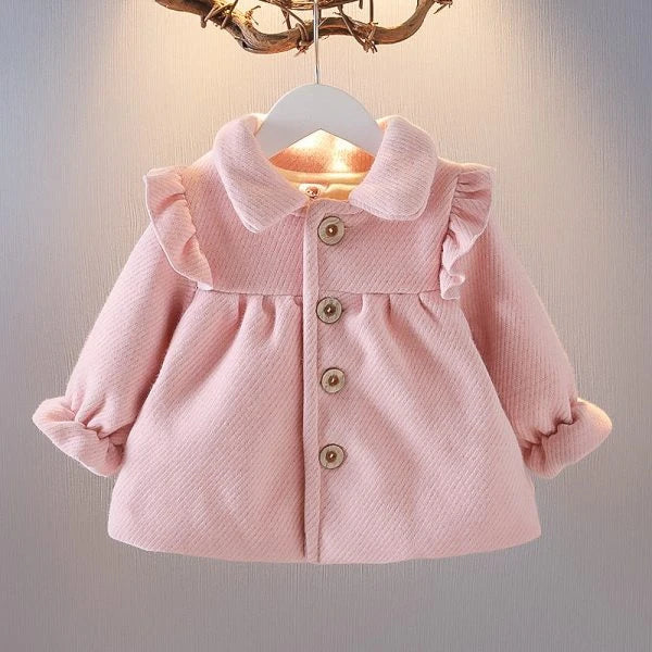 A soft and cozy baby velvet coat in a classic round-neck design, available in a variety of colors to complement any outfit.