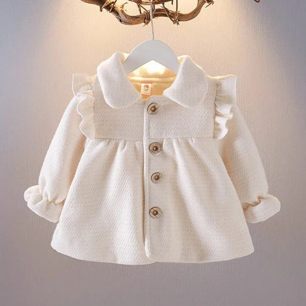 A soft and cozy baby velvet coat in a classic round-neck design, available in a variety of colors to complement any outfit.