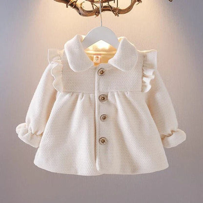 A soft and cozy baby velvet coat in a classic round-neck design, available in a variety of colors to complement any outfit.