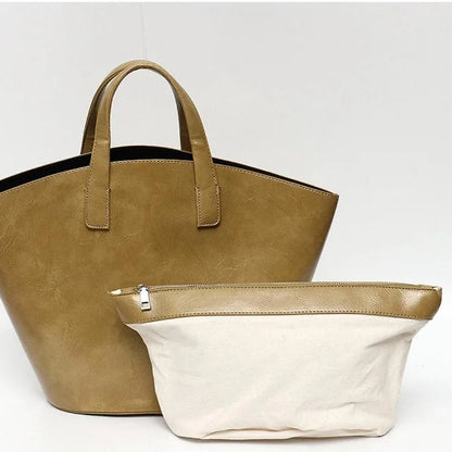 Elegant vegan leather tote bag with a unique bucket shape, versatile carrying options, and a secure zip liner for all your daily essentials.