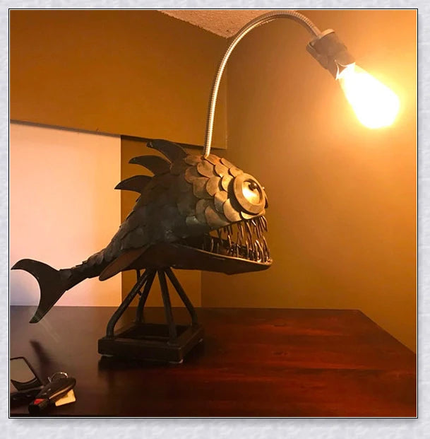 Steampunk angler fish-shaped lamp with rustic iron art tube design and warm, ambient lighting