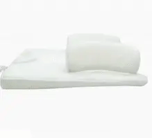 Newborn baby sleeping comfortably on the Baby Sleep Fixed Position & Anti Roll Pillow, with elevated head and air vent bumpers for optimal breathing and cooling.