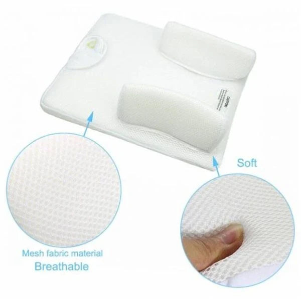 Newborn baby sleeping comfortably on the Baby Sleep Fixed Position & Anti Roll Pillow, with elevated head and air vent bumpers for optimal breathing and cooling.