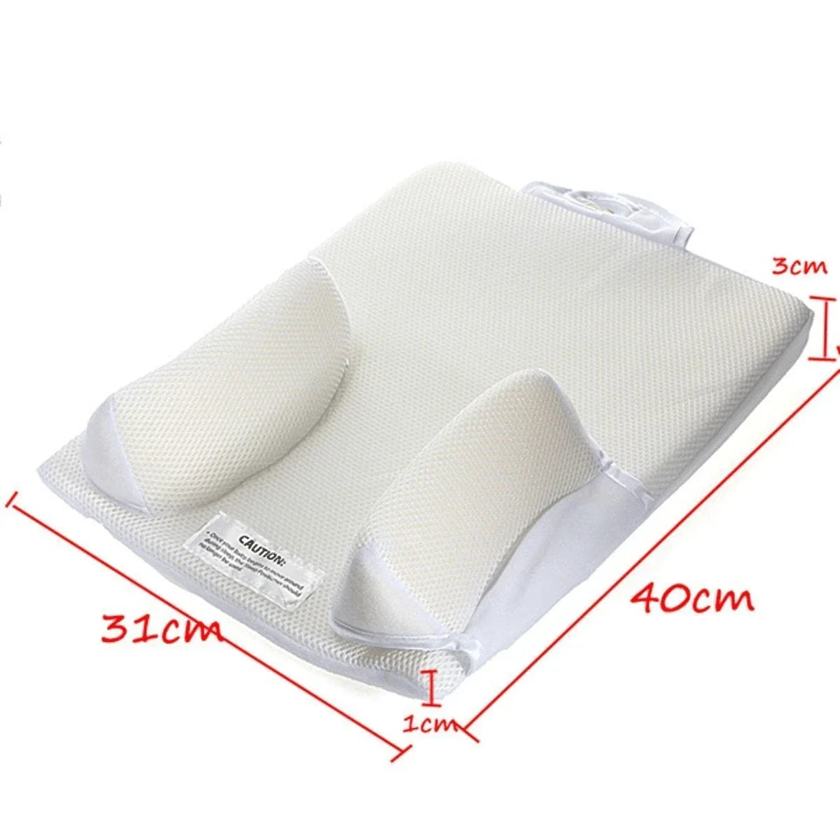 Newborn baby sleeping comfortably on the Baby Sleep Fixed Position & Anti Roll Pillow, with elevated head and air vent bumpers for optimal breathing and cooling.