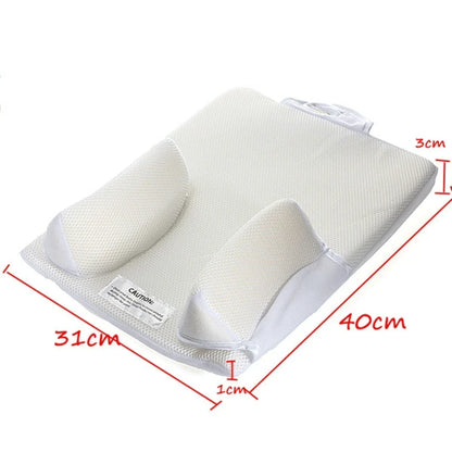 Newborn baby sleeping comfortably on the Baby Sleep Fixed Position & Anti Roll Pillow, with elevated head and air vent bumpers for optimal breathing and cooling.