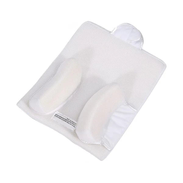 Newborn baby sleeping comfortably on the Baby Sleep Fixed Position & Anti Roll Pillow, with elevated head and air vent bumpers for optimal breathing and cooling.