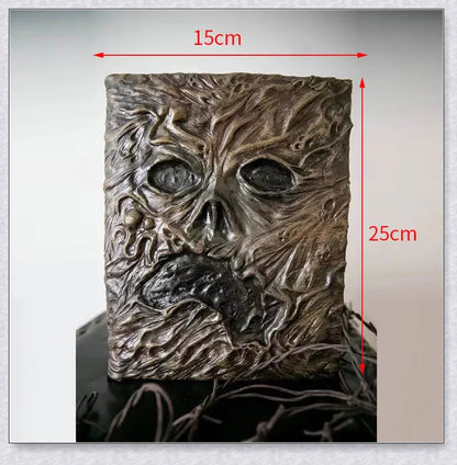 Necronomicon-inspired dark magic prop book with demonic face binding and barbed wire wrapping