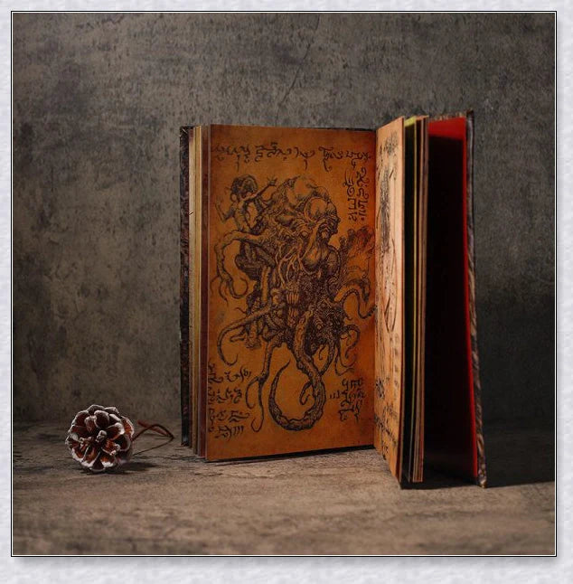 Necronomicon-inspired dark magic prop book with demonic face binding and barbed wire wrapping