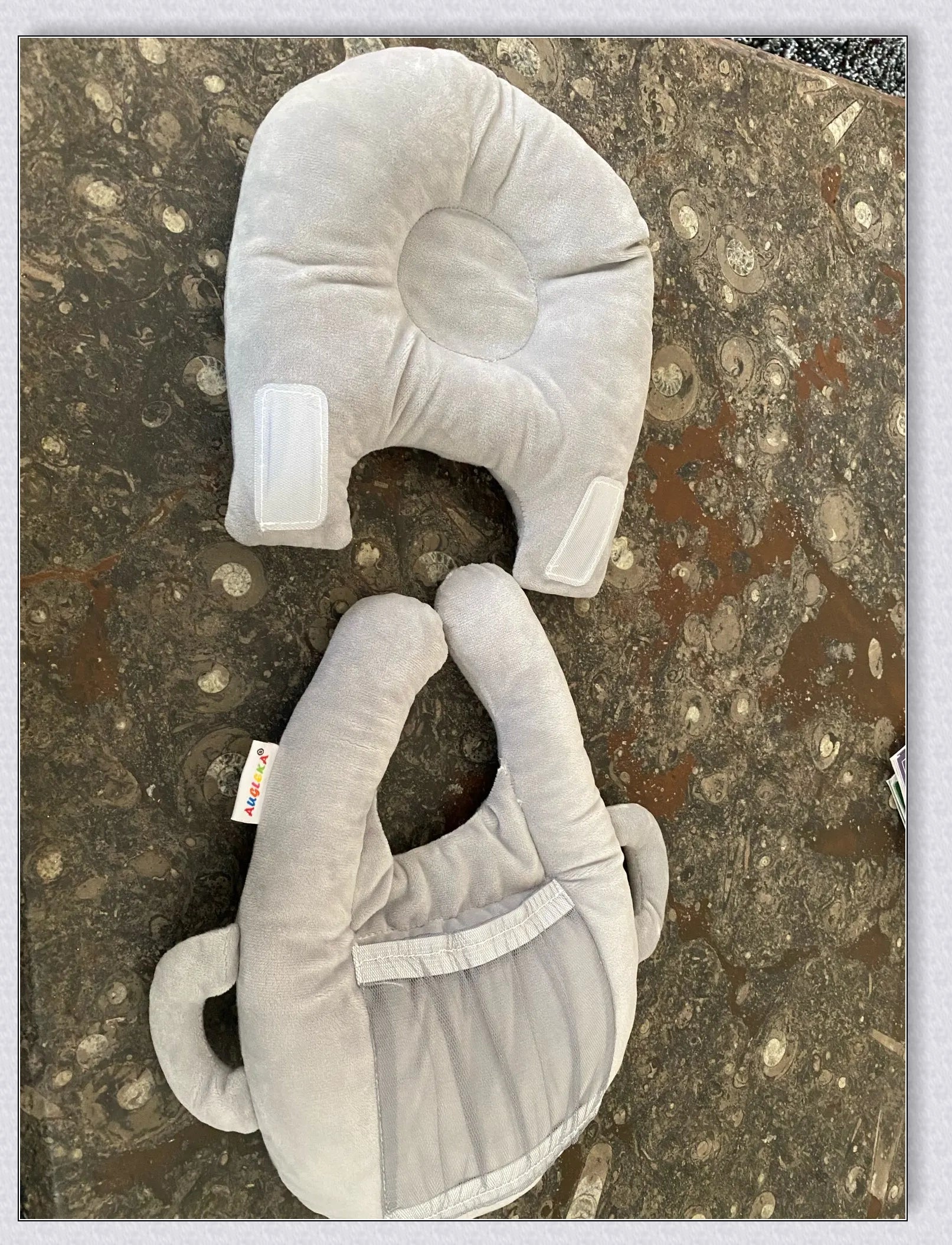 A soft, supportive pillow designed for hands-free baby feeding, featuring a secure bottle holder and premium, BPA-free materials.