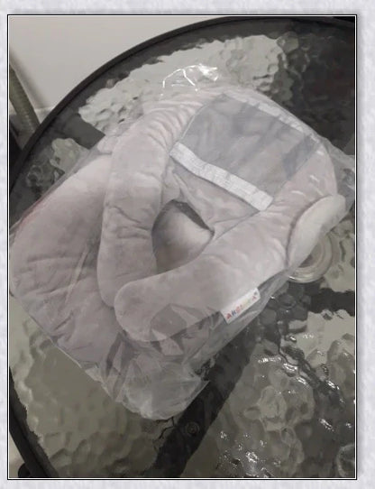A soft, supportive pillow designed for hands-free baby feeding, featuring a secure bottle holder and premium, BPA-free materials.