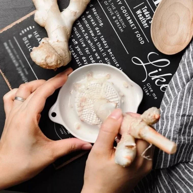 A ceramic ginger grater with a sleek, blade-free design for safe and efficient grating in the kitchen.