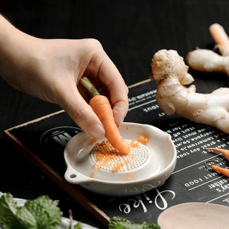 A ceramic ginger grater with a sleek, blade-free design for safe and efficient grating in the kitchen.