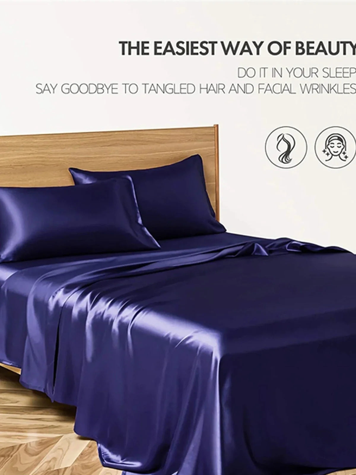 Navy blue floral pattern silk bedding set with quilt cover, fitted sheet, and two pillowcases on bed