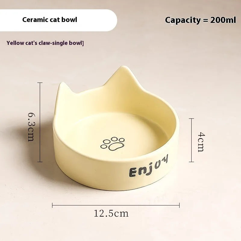 Porcelain cat bowl with anti-tumble wooden frame in pink with a cat paw design