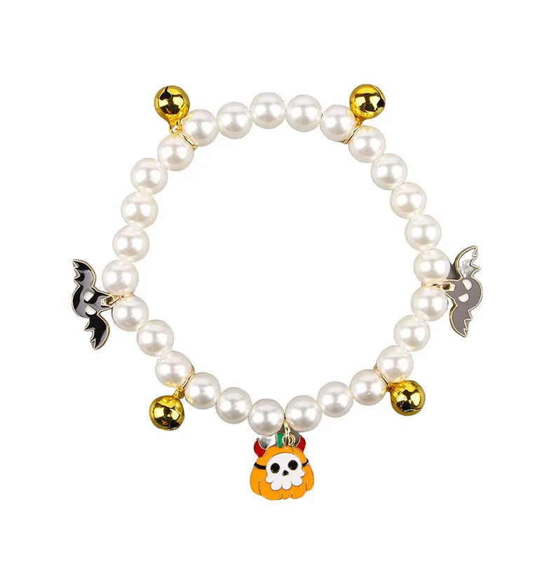 Halloween cat collar with simulated pearls and pumpkin-shaped charms in purple ghost, skull, and smiling designs.