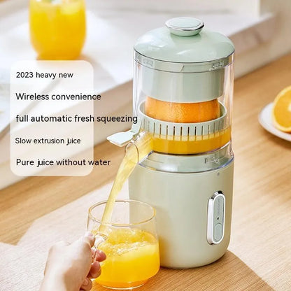 Fresh green portable electric juicer with USB charging cable and orange on a wooden table