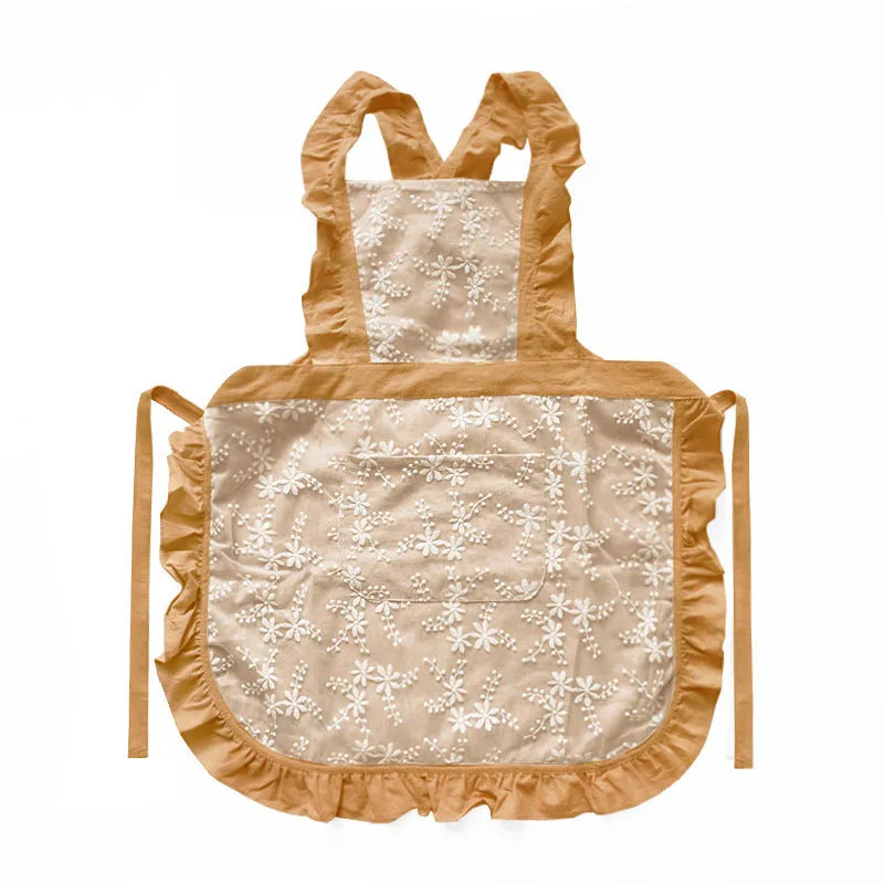 Minimalist kitchen apron with X-strap design in cotton linen fabric showing lace trim detail