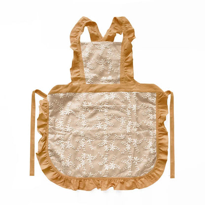 Minimalist kitchen apron with X-strap design in cotton linen fabric showing lace trim detail