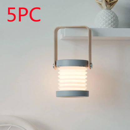 White foldable USB rechargeable LED night light in both table lamp and tall lantern modes.