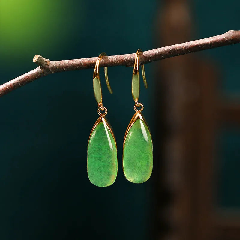 A pair of retro-style geometric copper earrings with water droplet details in a jade-toned electroplated finish.