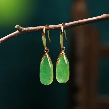 A pair of retro-style geometric copper earrings with water droplet details in a jade-toned electroplated finish.