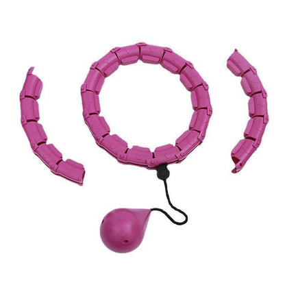 Pink massage soft ball with a detachable black belt, shown on a fitness mat.