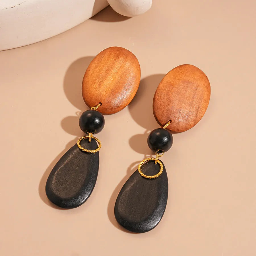 Wooden ellipse drop earrings with brown-black colour and silver needle accents