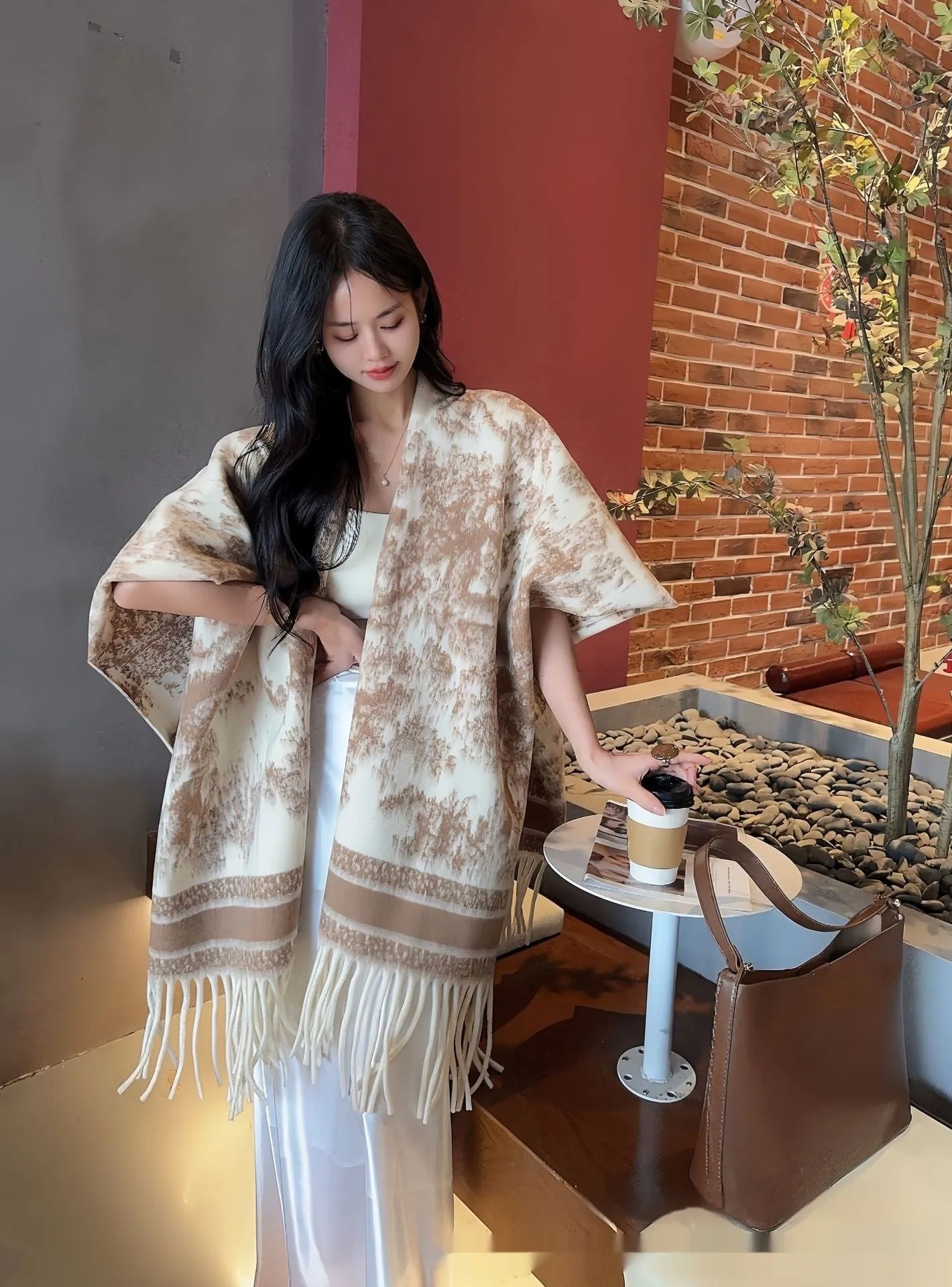 Women's polyester tassel scarf cape in free-size design showing 15 cm fringe detailing and shawl-style drape