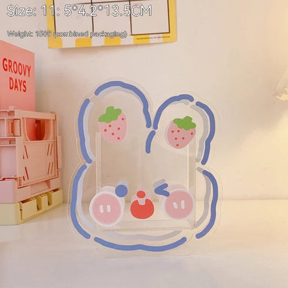 Square transparent acrylic storage box with printed character theme containing coloured pens