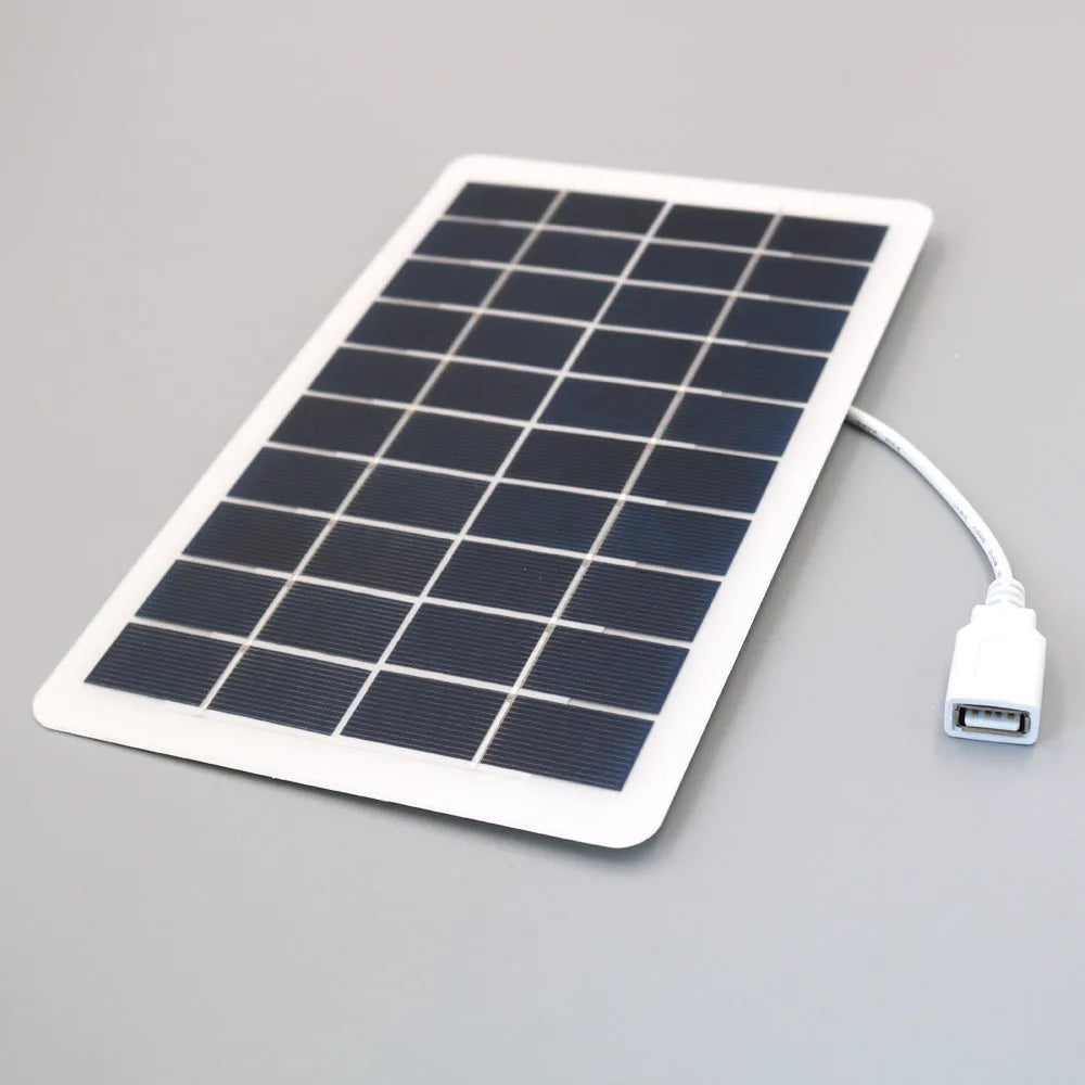 Black solar panel mobile phone charger with USB port showing compact portable design