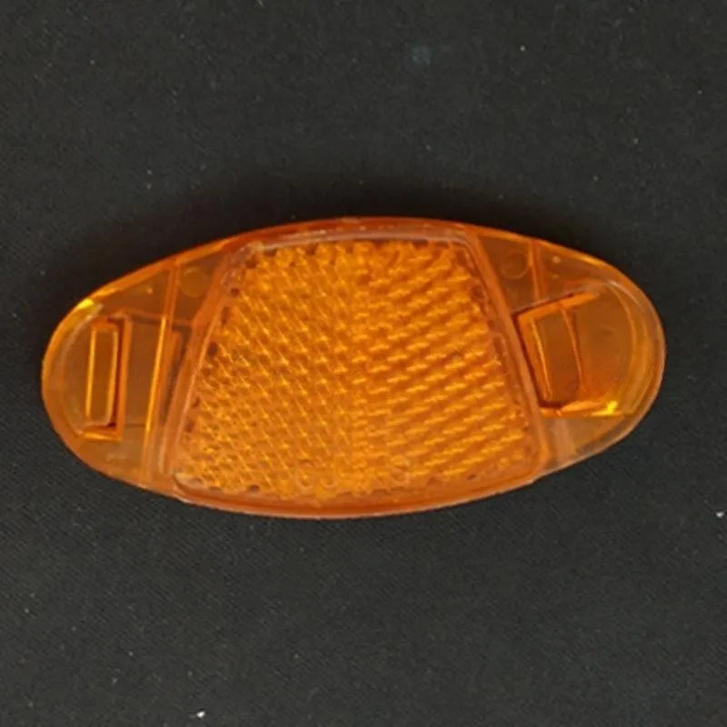 Four white bicycle spoke reflectors showing dimensions of 7.2cm by 3.5cm