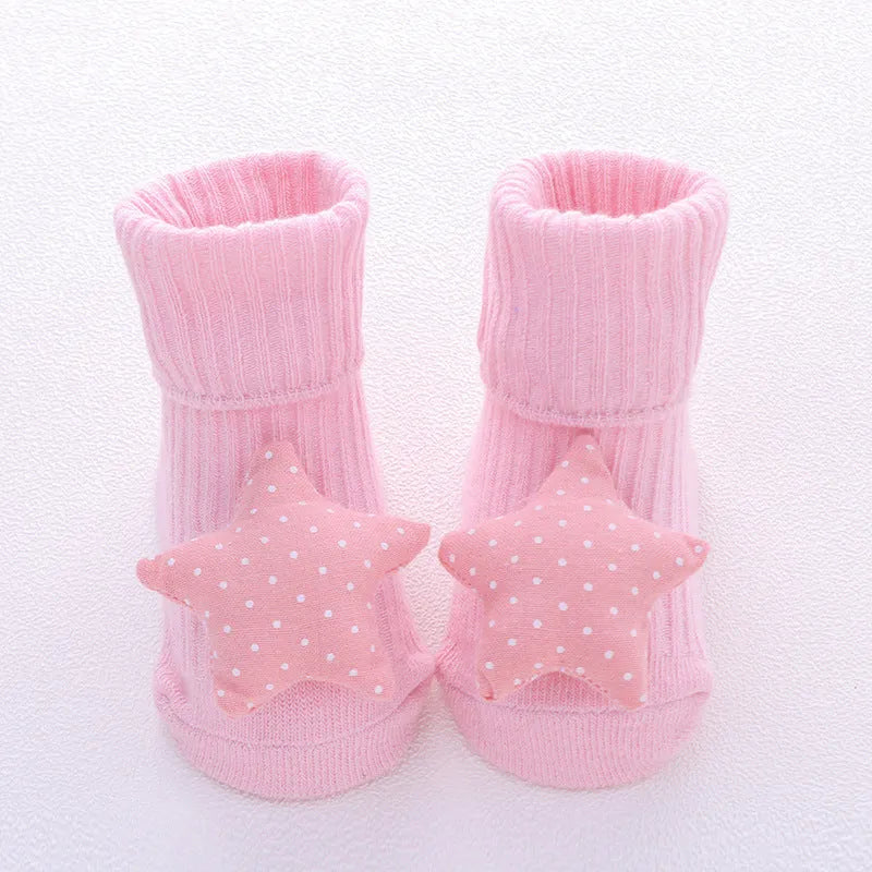 Cotton baby floor socks in assorted colours and patterns including bows, stars, and animal designs.