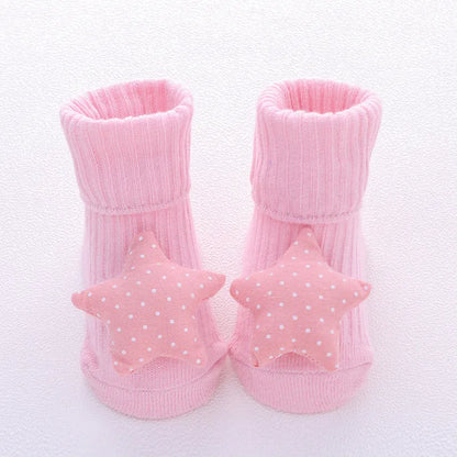 Cotton baby floor socks in assorted colours and patterns including bows, stars, and animal designs.