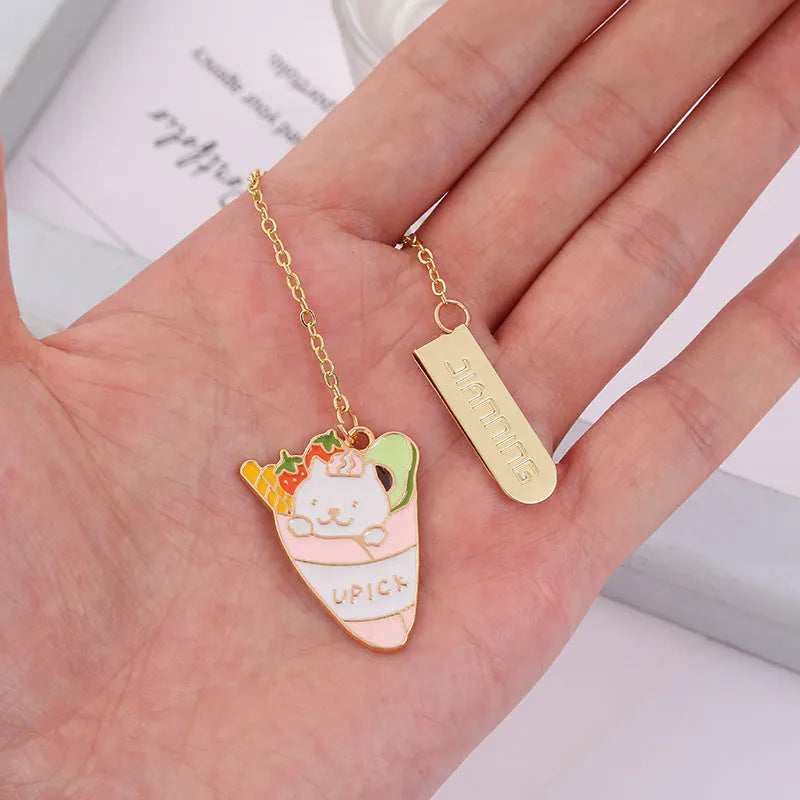 Jane Lime Foodie cat creative metal bookmark with cartoon pendant on a book page.